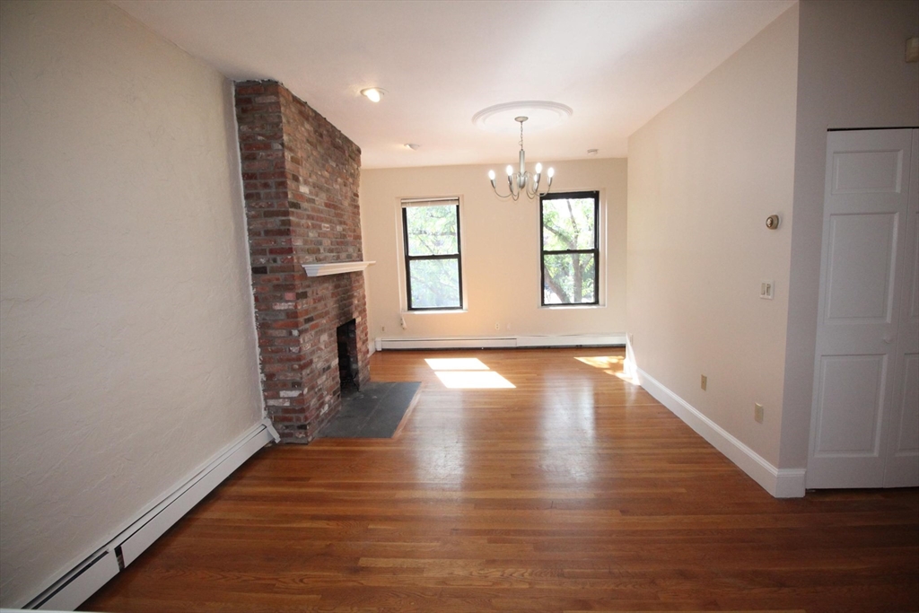 11 Worcester Street, Unit 2 Boston, MA 02118 - Photo 3 of 23 an empty room with wooden floor and windows