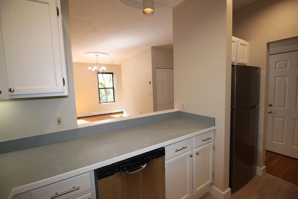 11 Worcester Street, Unit 2 Boston, MA 02118 - Photo 7 of 23 a kitchen with a sink cabinets and a refrigerator