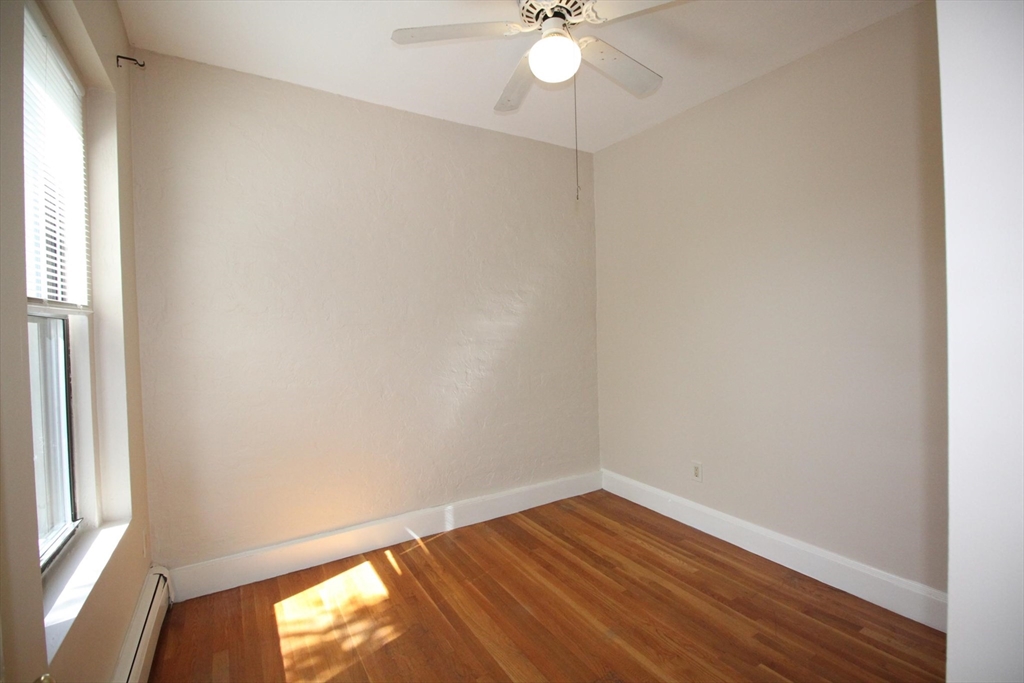 11 Worcester Street, Unit 2 Boston, MA 02118 - Photo 10 of 23 an empty room with wooden floor and windows