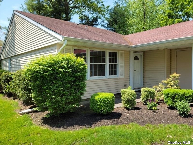 178 Edinburgh Drive, Unit 178 Ridge, NY 11961 - Photo 1 of 1 a view of a house with potted plants and a bench