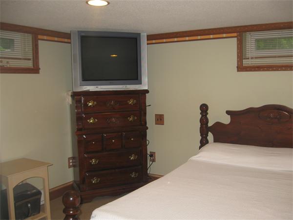 39 Griffin Street Springfield, MA 01104 - Photo 15 of 20 a bedroom with a bed and a flat tv screen on dresser
