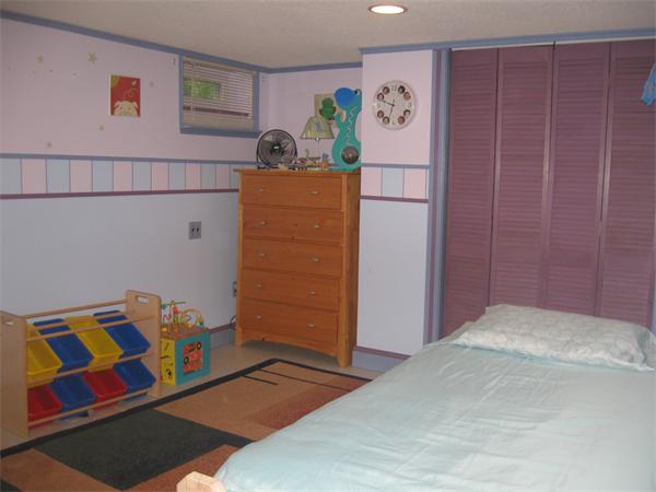 39 Griffin Street Springfield, MA 01104 - Photo 16 of 20 a bedroom with a bed and cabinets
