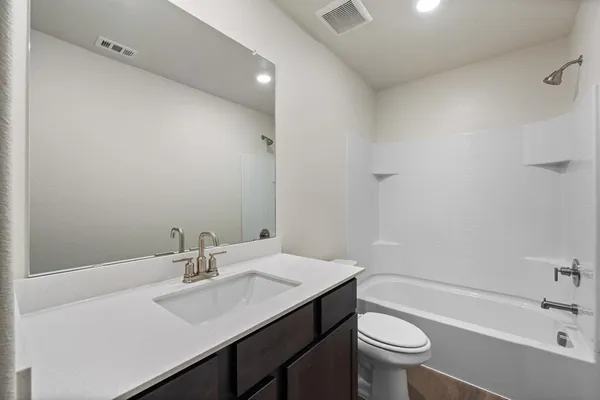 a bathroom with a sink a toilet and a bathtub