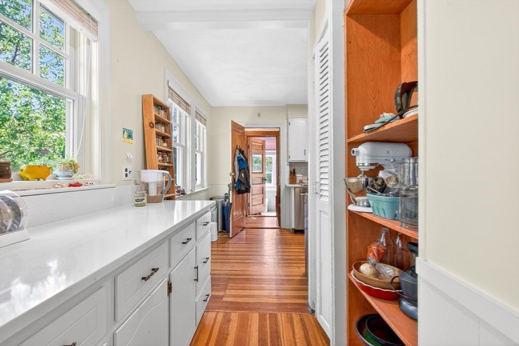 76-78 Lewis Road Belmont, MA 02478 - Photo 25 of 36 a view of a hallway with wooden floor and a large window