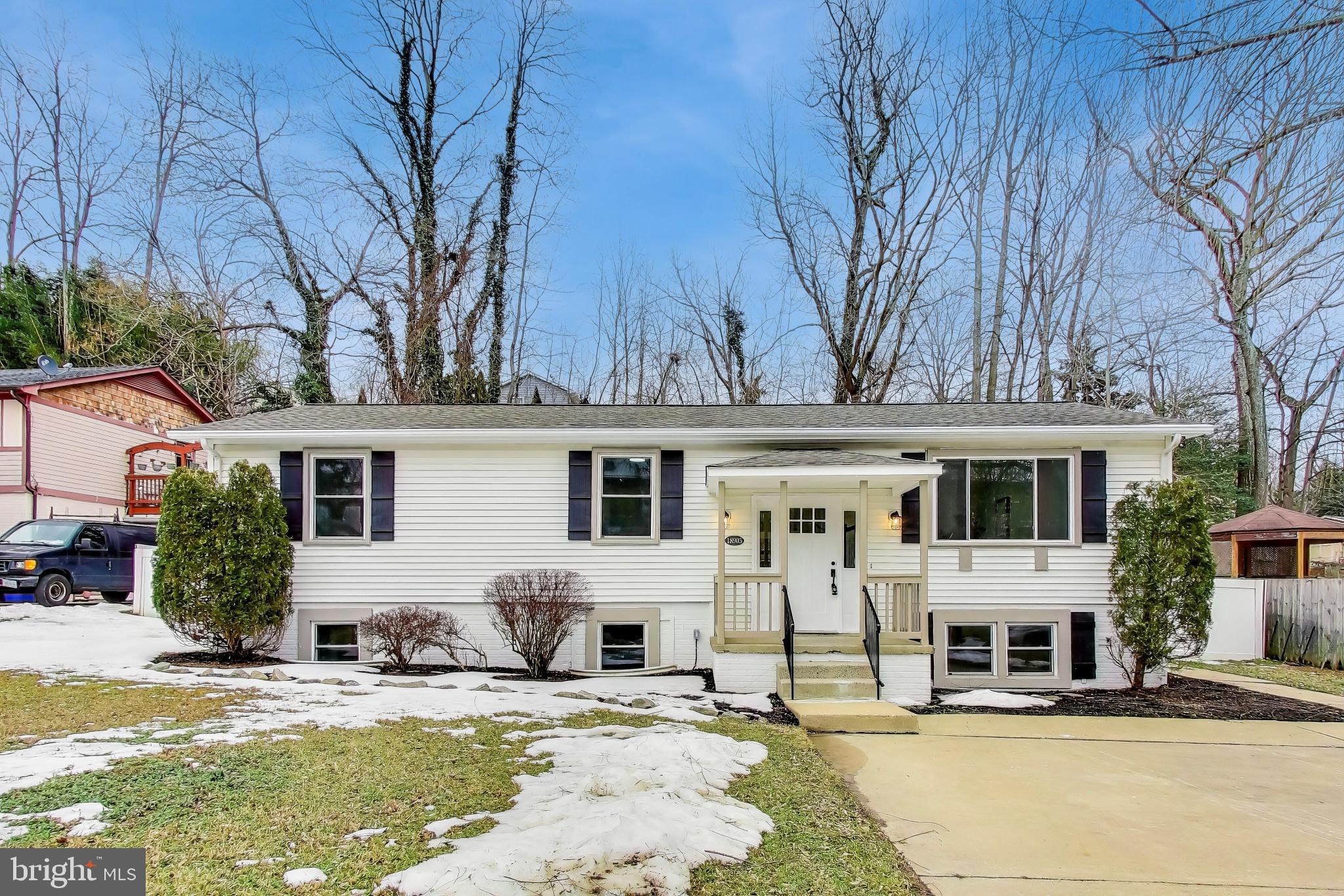 a view of a house with snow on the side of the road