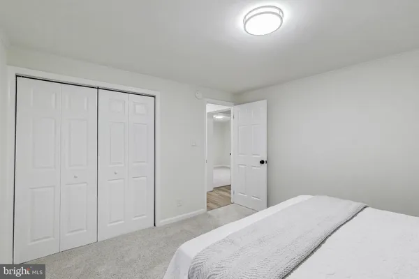 a bedroom with a bed and a shower