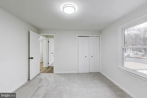 a view of an empty room and a window