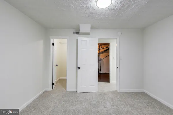 a bathroom with a bathtub shower sink mirror vanity and toilet