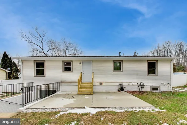 a view of a backyard with a white house