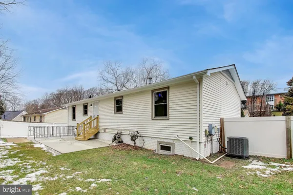 a view of a white house with iron fence