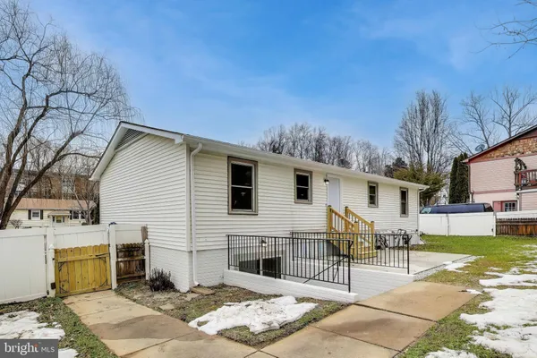 a view of a house with a yard covered in snow