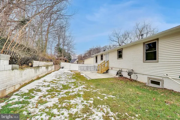 a picture of a bench in front of a white house