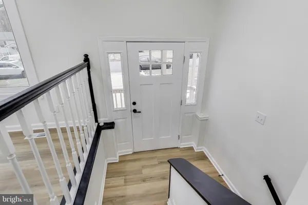 a view of an entryway with wooden floor and stairs