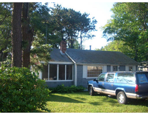 52 Uncle Henrys Road Mashpee, MA 02649 - Photo 2 of 2 a front view of a house with garden