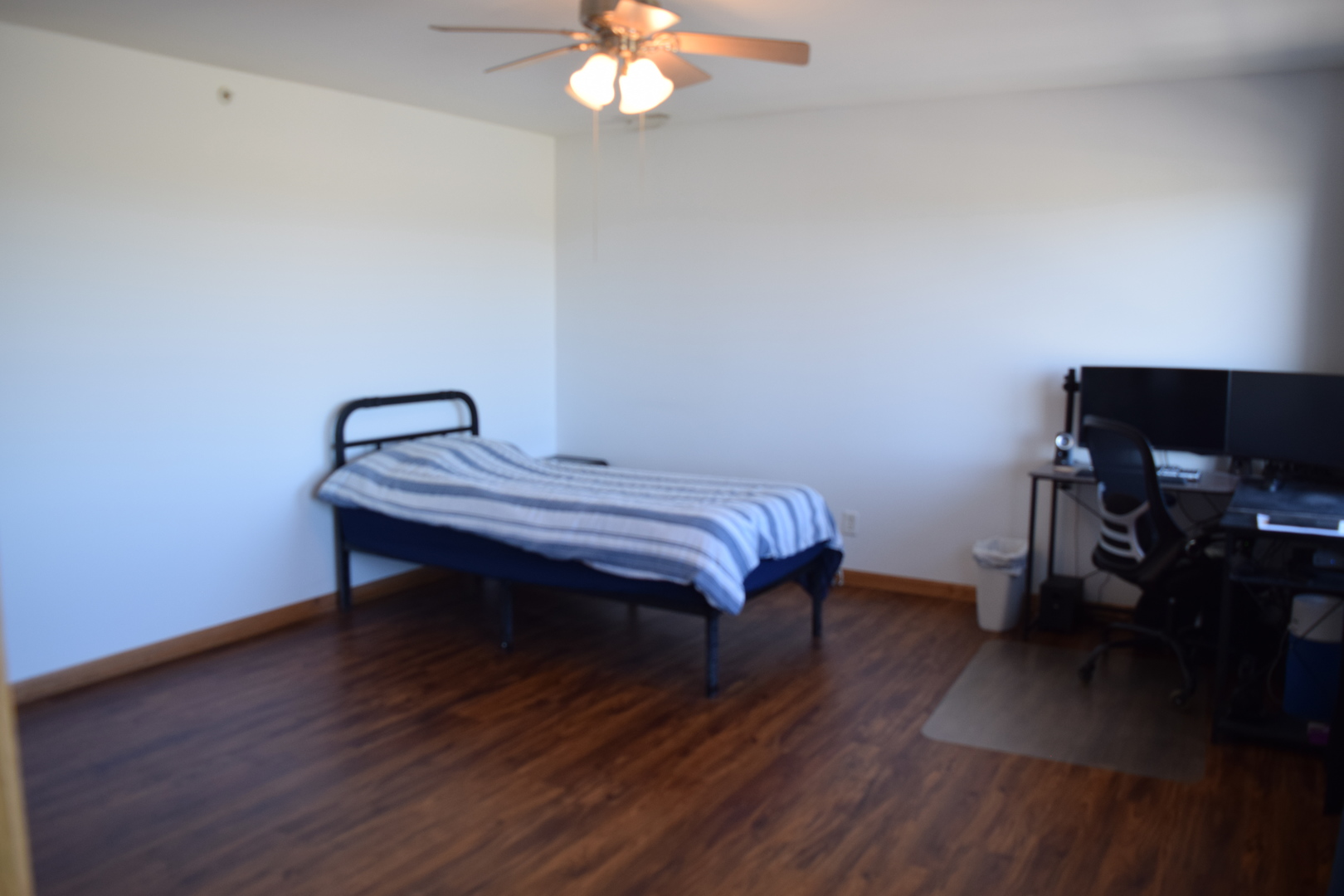 565 North Strack Street, Unit 302 Cortland, IL 60112 - Photo 10 of 15 a bedroom with a bed and a chandelier