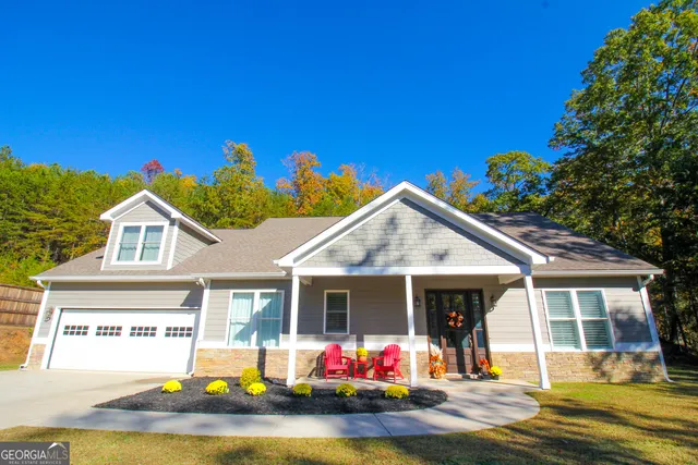 a view of a house with swimming pool and sitting area