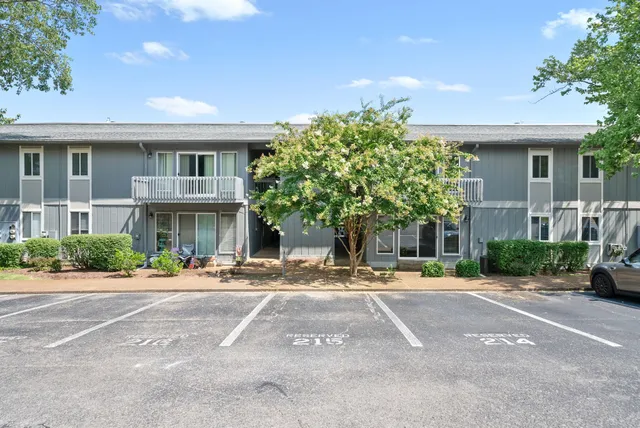 a front view of a building with trees
