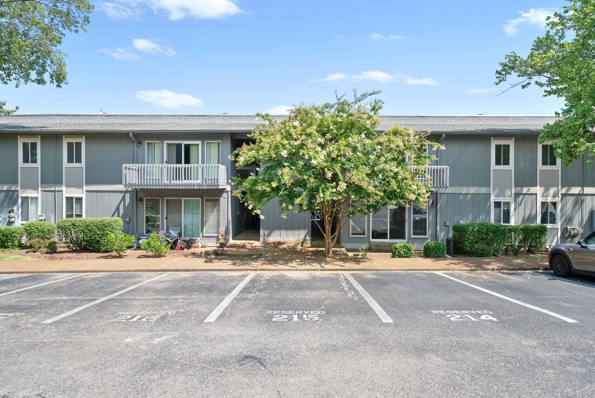 a front view of a building with trees