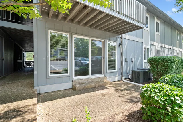 a view of empty room with wooden floor and window