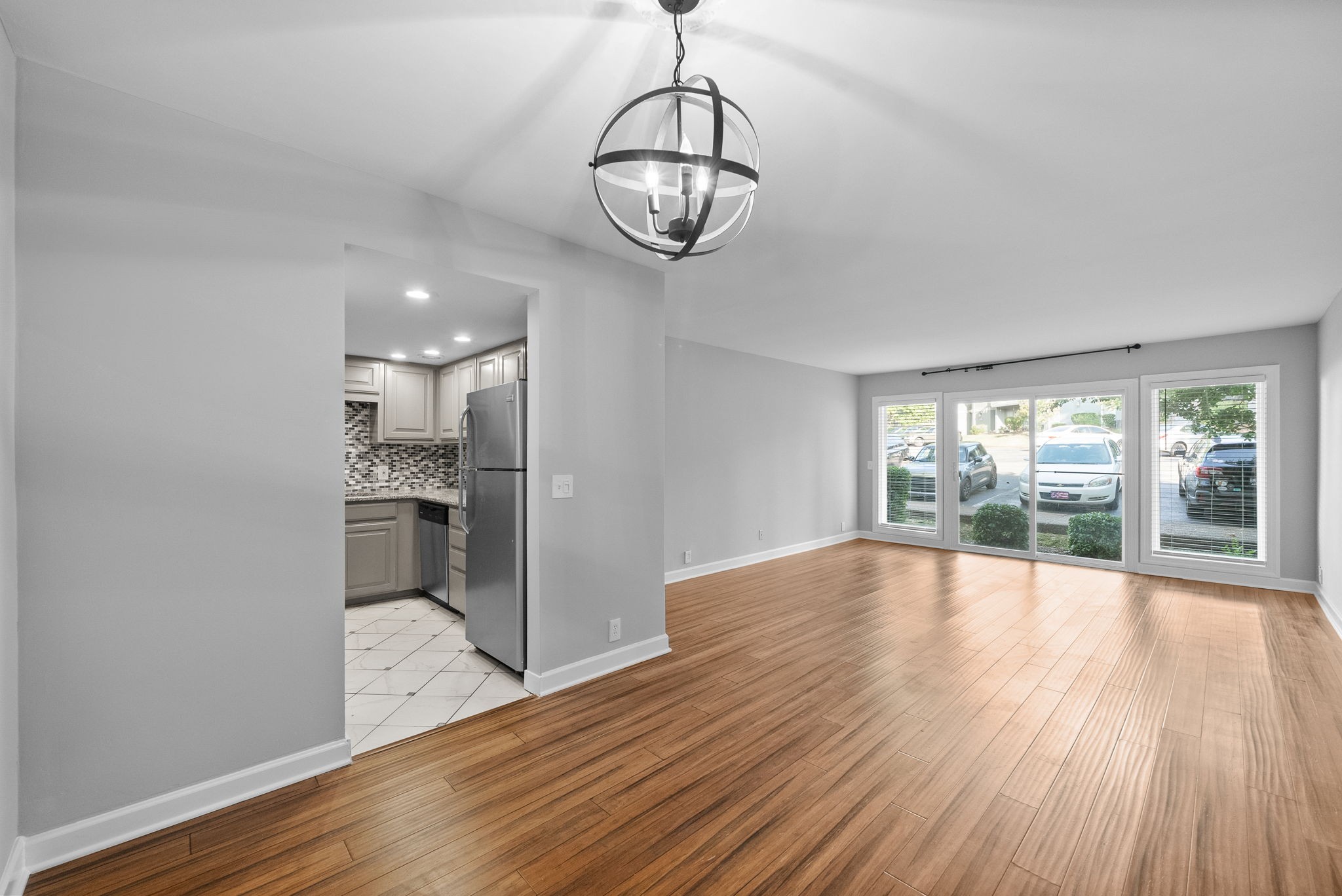 21 Vaughns Gap Road Nashville, TN 37205 - Photo 10 of 27 a view of a room with wooden floor chandeliers and kitchen view