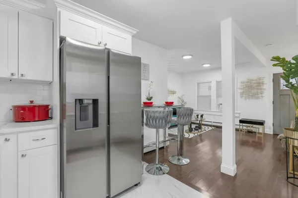 a kitchen with kitchen island a sink cabinets and wooden floor