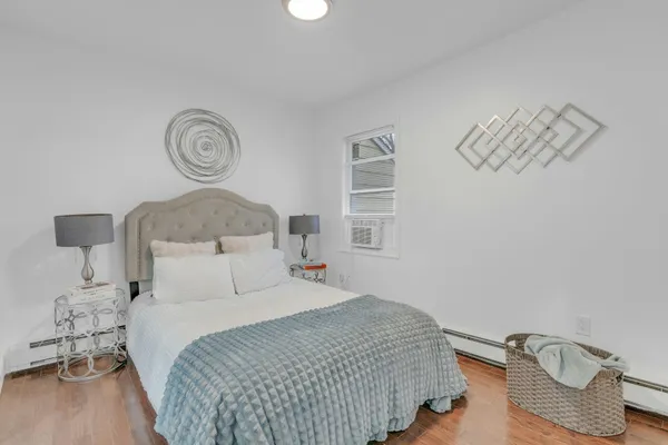 a bedroom with bed and a window