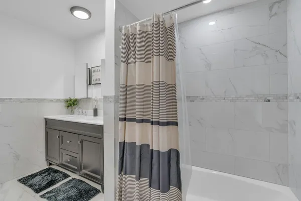 a spacious bathroom with a sink and a mirror