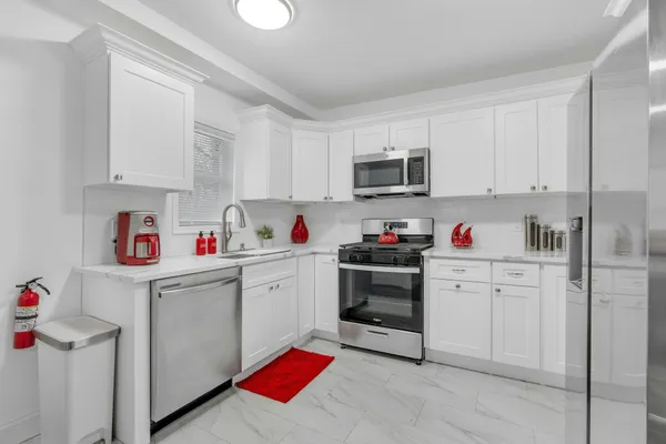 a kitchen with stainless steel appliances granite countertop a refrigerator sink and cabinets
