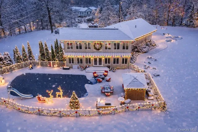 a view of a house with backyard and sitting area