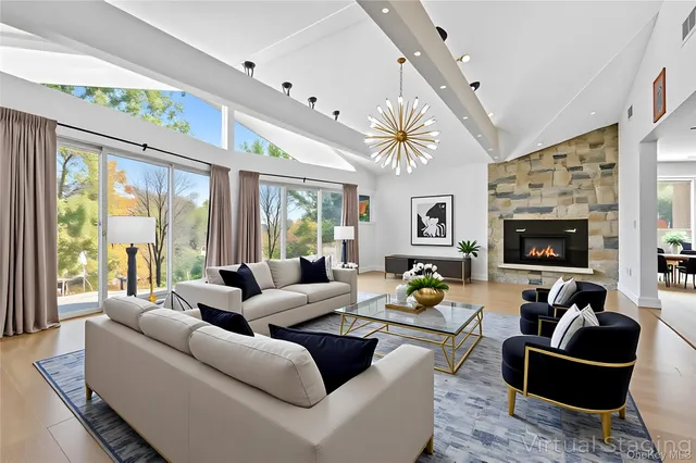 a living room with lots of furniture and a chandelier