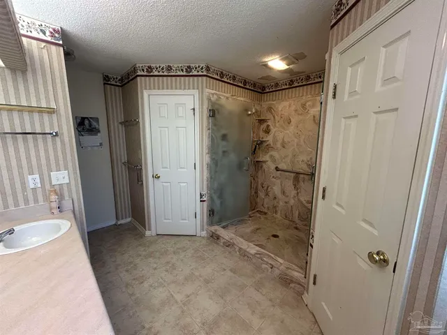 a bathroom with a shower and a sink