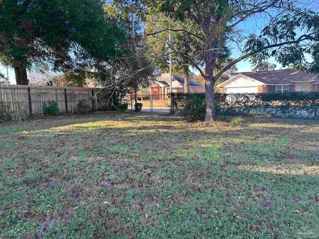 a view of a yard with a house and trees
