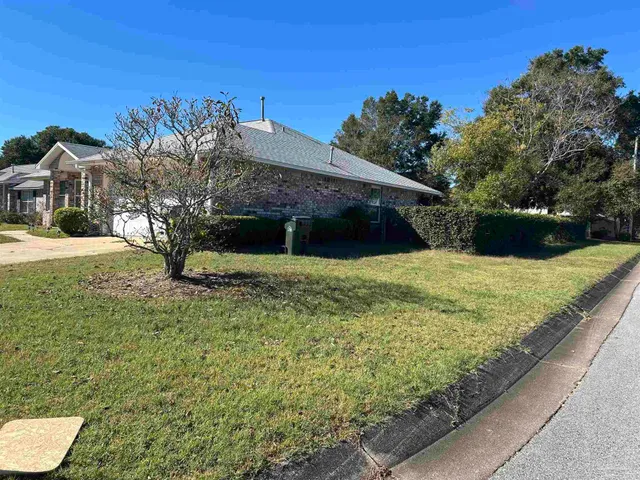 a view of a garden with a building in the background