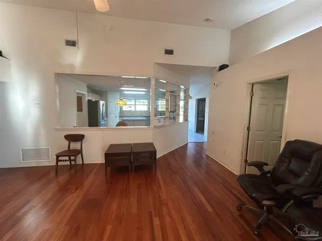a dining room with furniture and wooden floor