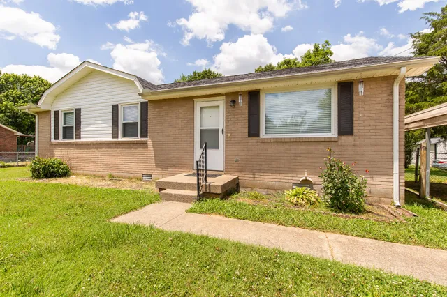 a front view of house with yard and green space