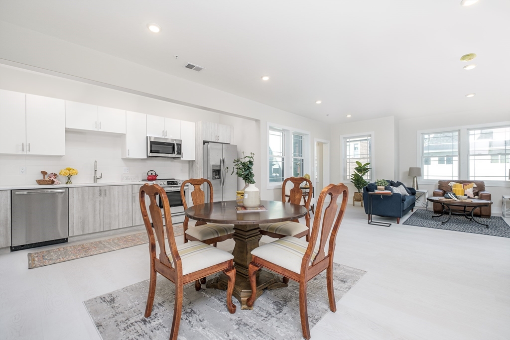 1540 North Shore Road, Unit 202 Revere, MA 02151 - Photo 4 of 19 a dining room with furniture and a view of kitchen