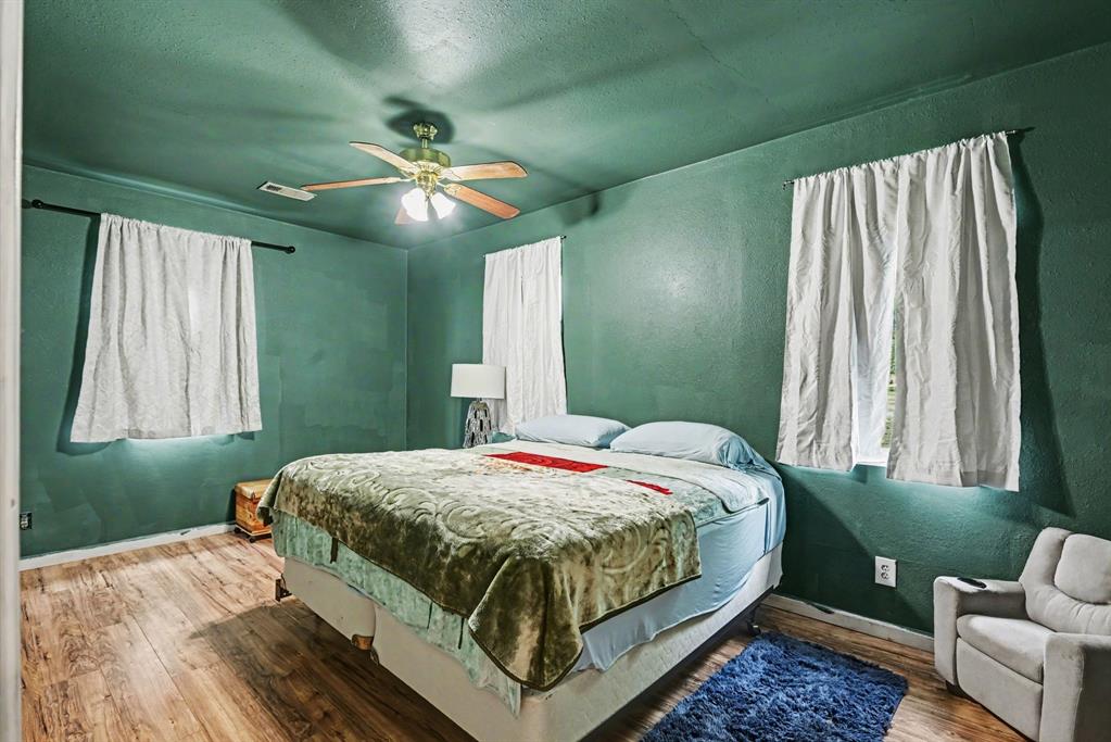 6694 Hutcheson Hill Road Springtown, TX 76082 - Photo 17 of 37 a bedroom with a bed and window