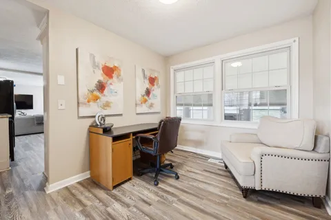 a living room with furniture a flat screen tv and a window