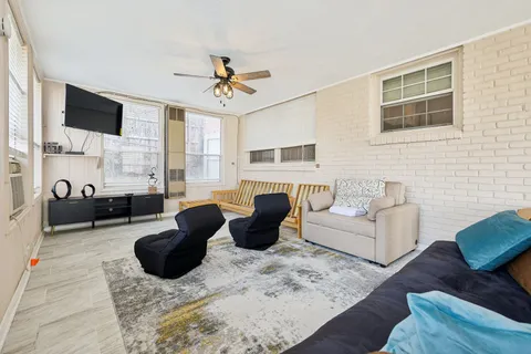 a living room with furniture fireplace and a flat screen tv