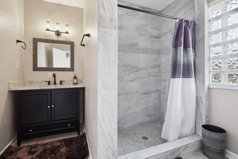 a bathroom with a sink a toilet and shower