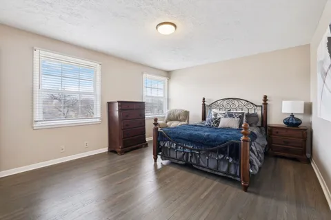 a bedroom with furniture and wooden floor