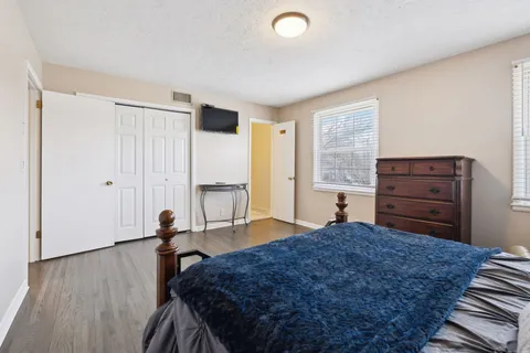 a bed room with a bed and a window