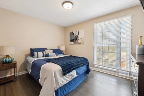 a bed room with a bed and a chair