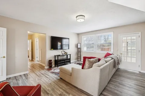 a living room with furniture fireplace and flat screen tv