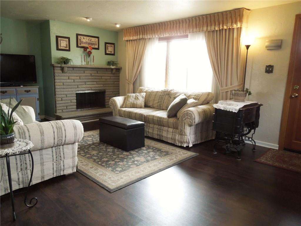 2043 Borland Road Pittsburgh, PA 15243 - Photo 5 of 24 Living room with wood burning fireplace - Newer laminate floors & painted walls.