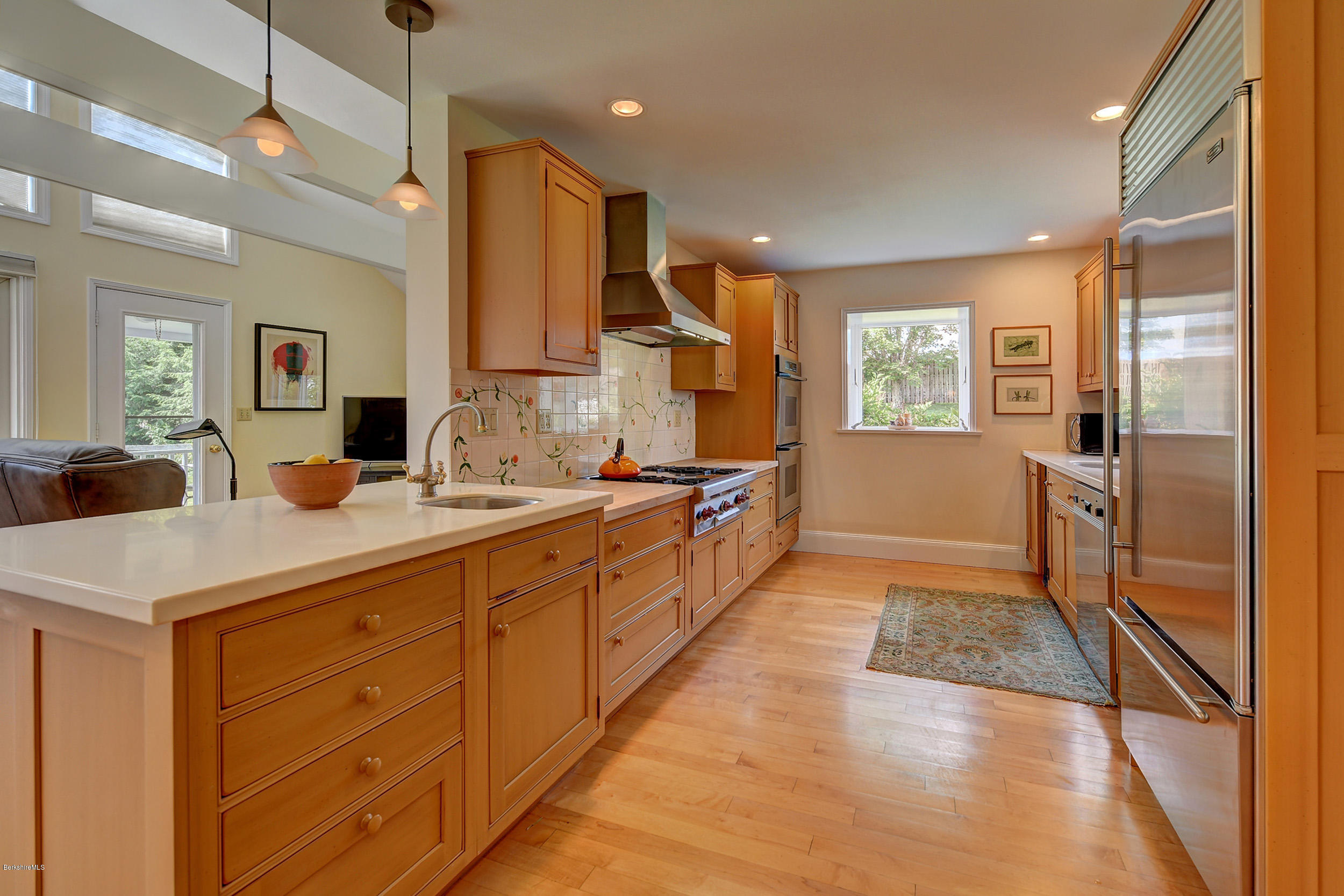 123 State Road Richmond, MA 01201 - Photo 15 of 32 a large kitchen with stainless steel appliances a large counter top a stove a sink and a refrigerator