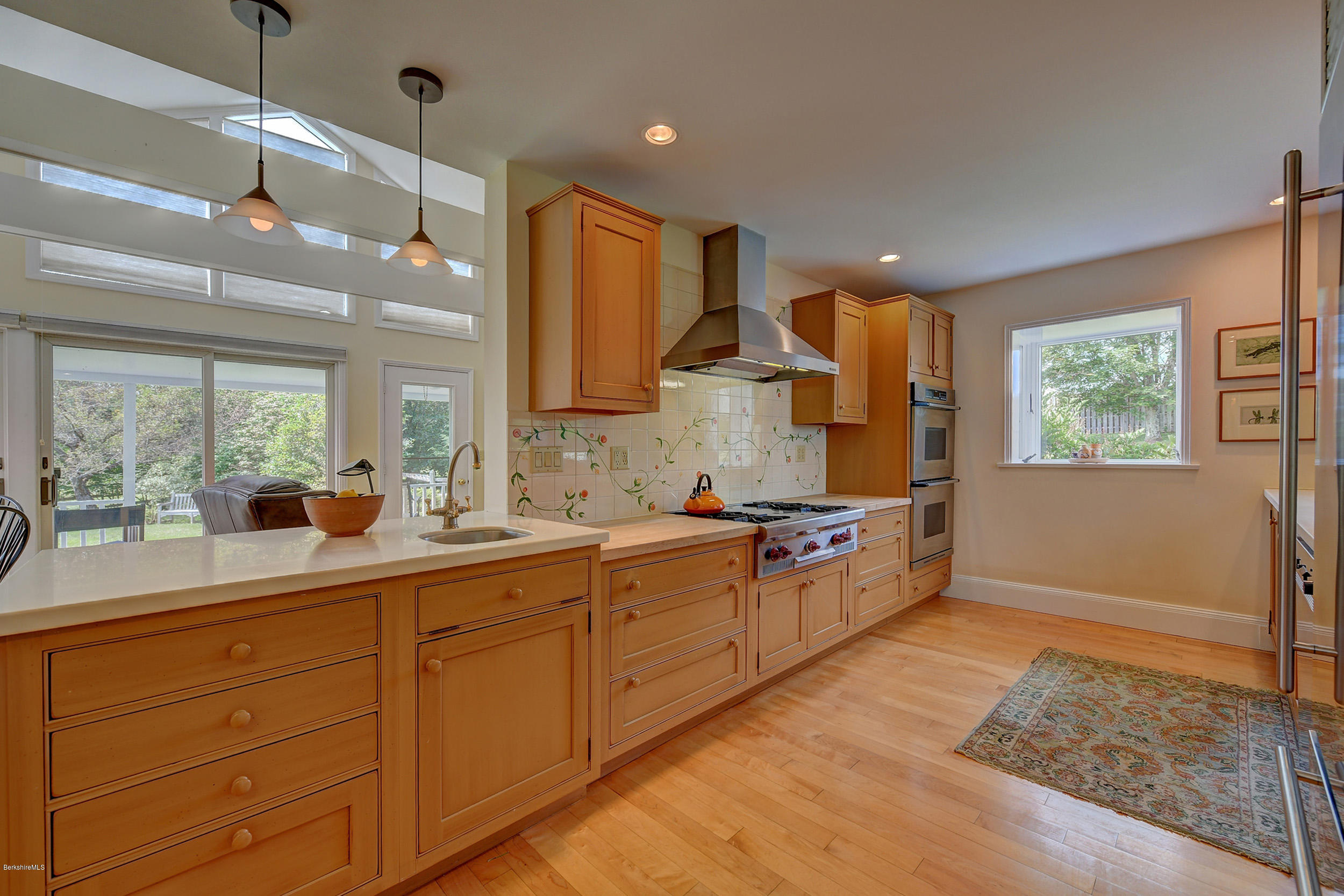 123 State Road Richmond, MA 01201 - Photo 17 of 32 a large kitchen with a sink window and cabinets