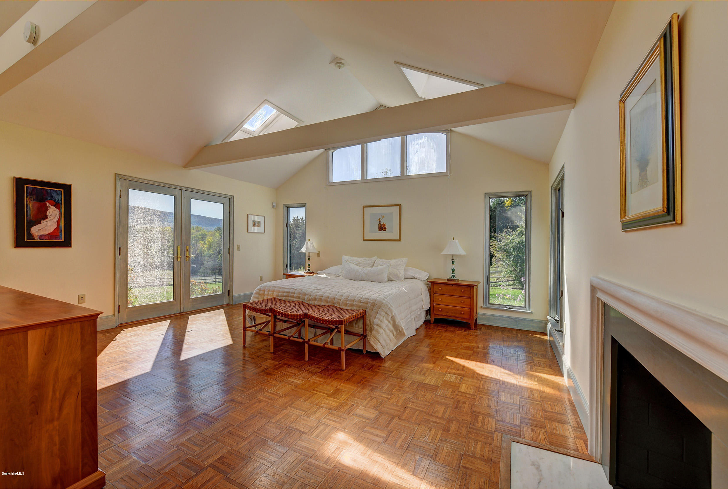 123 State Road Richmond, MA 01201 - Photo 18 of 32 a spacious bedroom with a bed and a fireplace