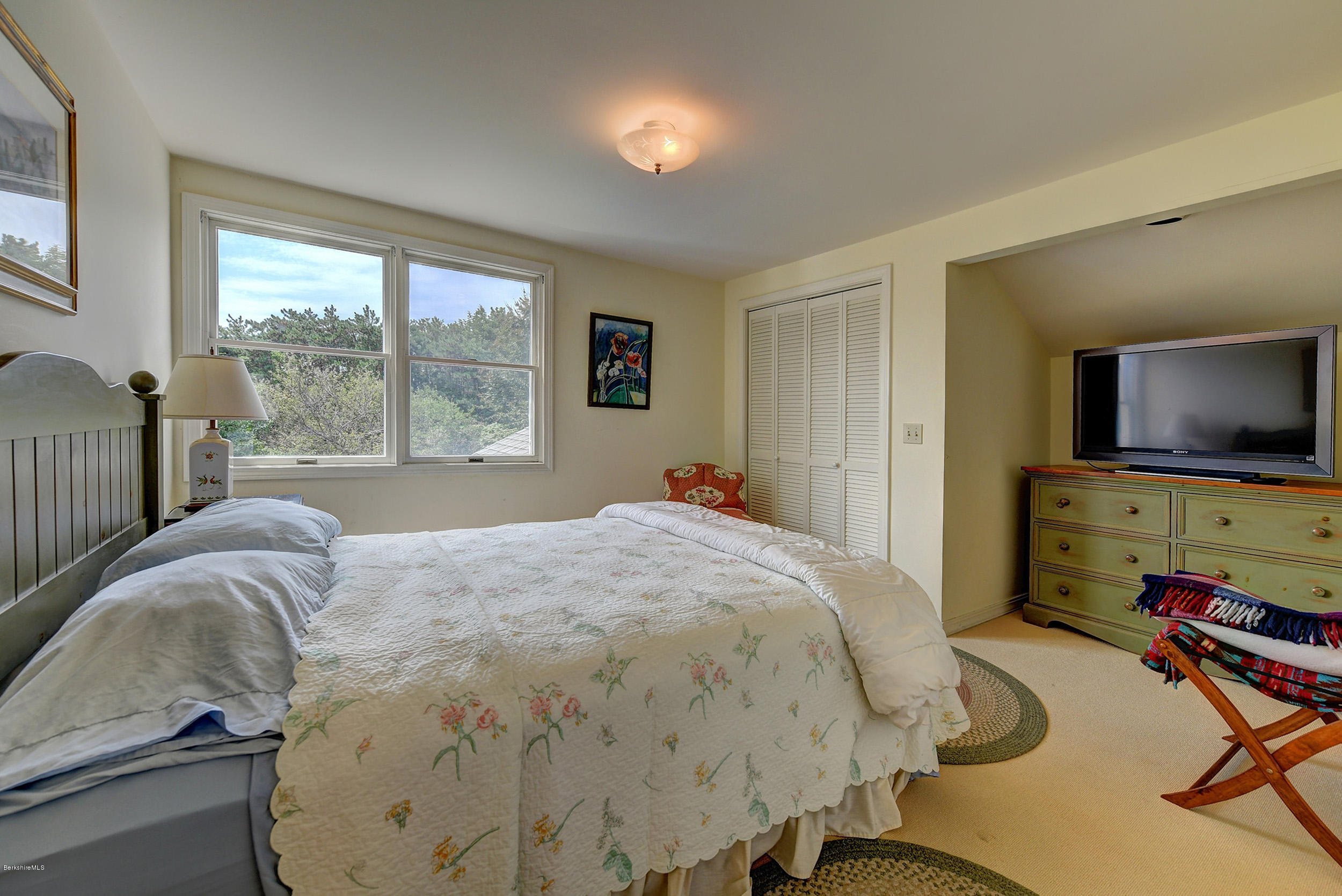 123 State Road Richmond, MA 01201 - Photo 24 of 32 a bedroom with a bed and large windows