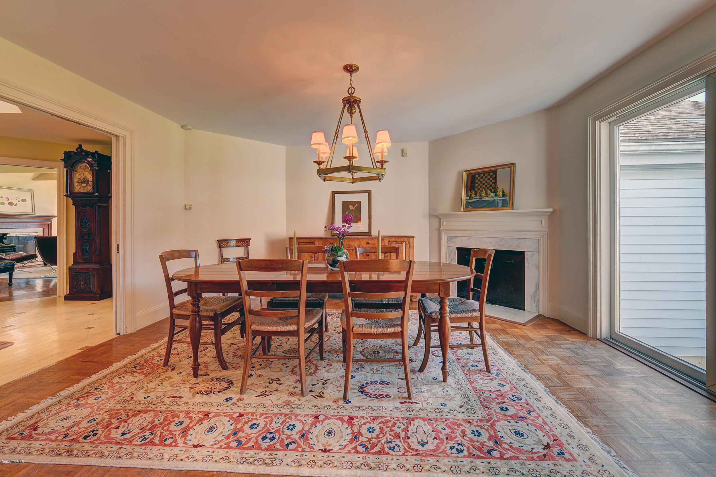 123 State Road Richmond, MA 01201 - Photo 10 of 32 a dining room with wooden floor a chandelier a wooden table and chairs